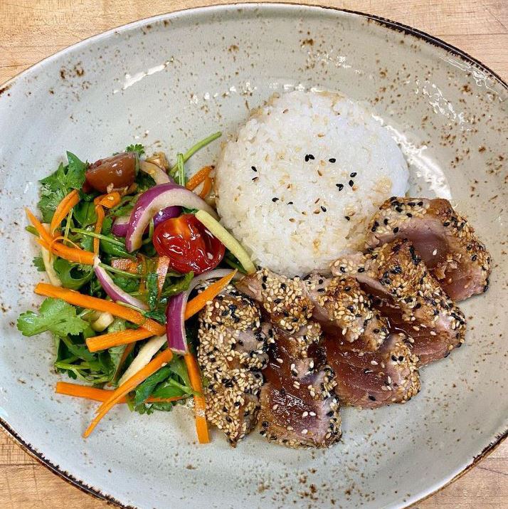 Sesame crusted tuna seared rare served with jasmine rice, topped with ponzu