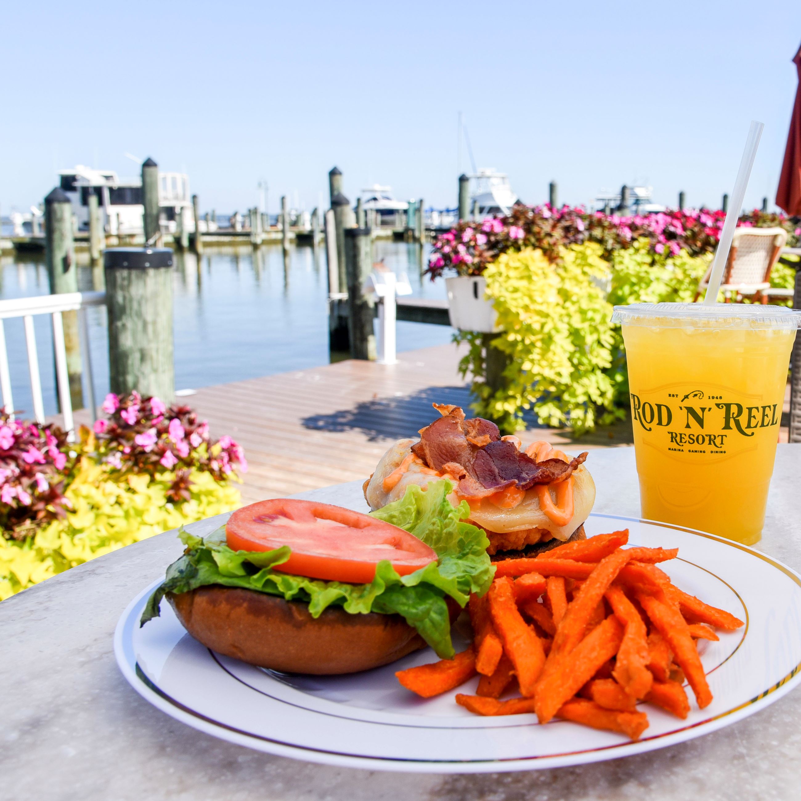Burger, fries and a beverage with a waterside view