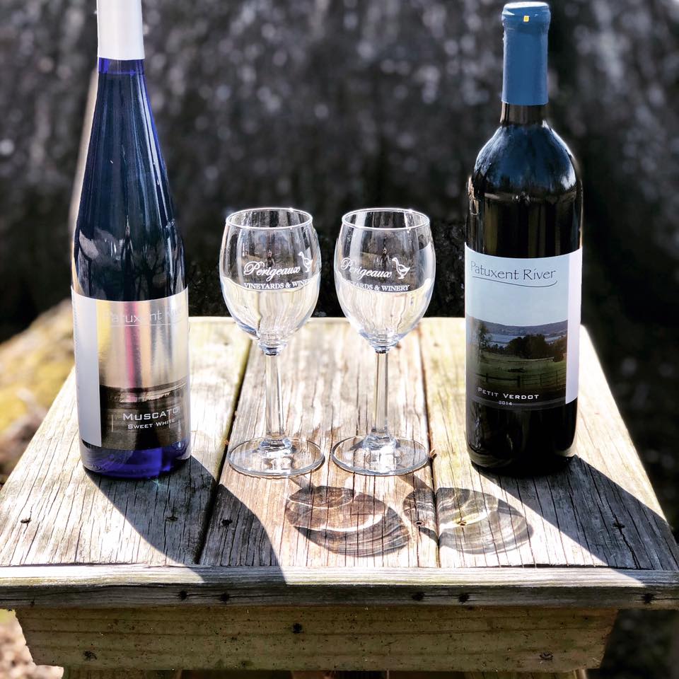 Two wine bottles and two wine glasses on a table