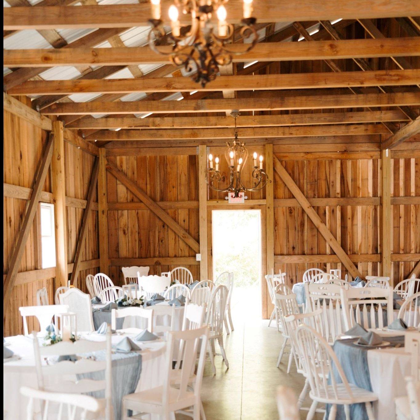 interior of barn space with white tables and chairs